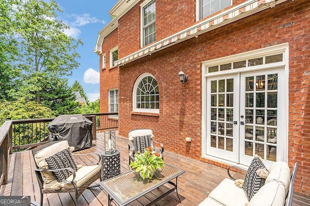 wooden deck featuring french doors, area for grilling, and an outdoor living space