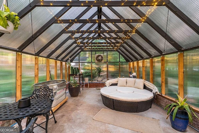 sunroom featuring lofted ceiling