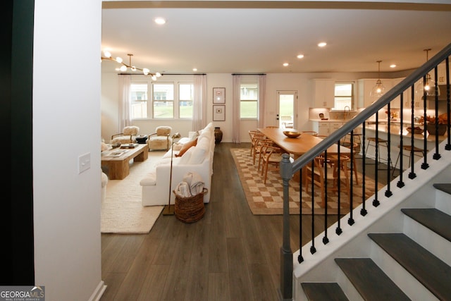 living area with recessed lighting, a healthy amount of sunlight, and dark wood finished floors