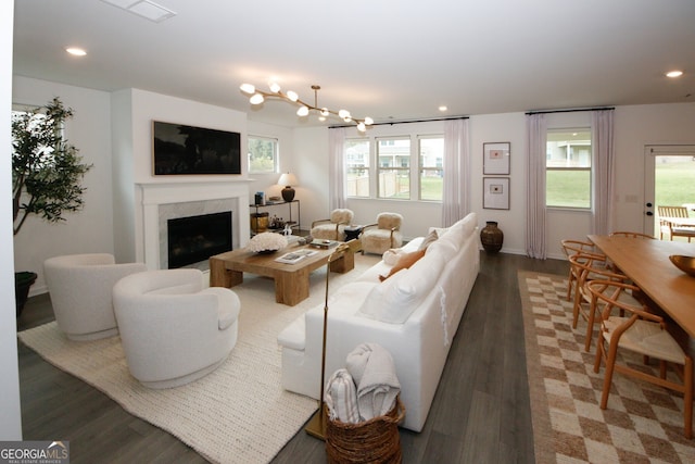 living room featuring recessed lighting, a fireplace, and dark wood finished floors