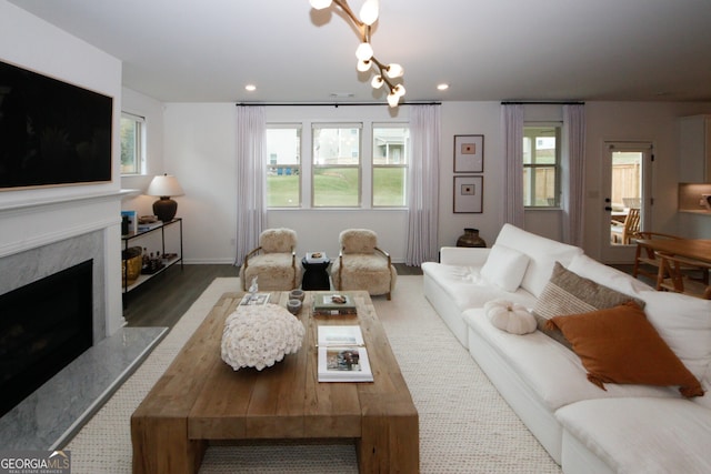 living area with a premium fireplace, a wealth of natural light, and recessed lighting