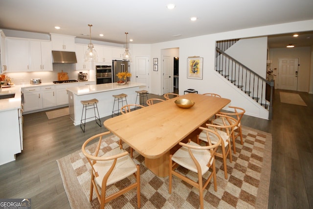 dining room featuring dark wood-style floors, stairway, and recessed lighting