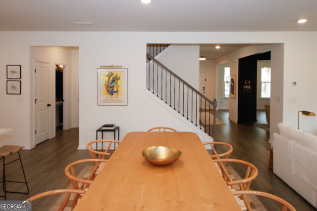 dining room featuring dark wood-type flooring, recessed lighting, stairway, and baseboards