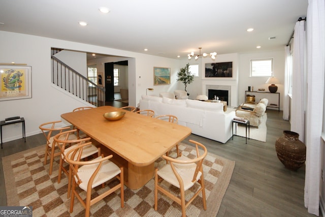 dining room featuring dark wood-style floors, stairway, an inviting chandelier, and recessed lighting