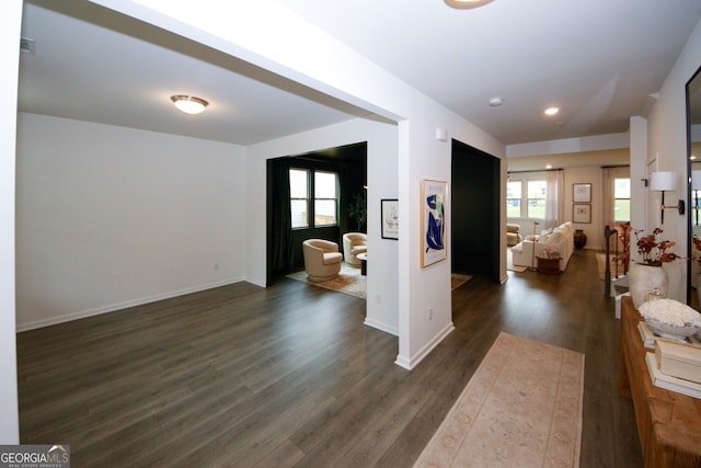 interior space with dark wood-style floors, visible vents, and baseboards