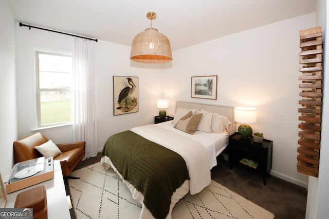 bedroom with carpet flooring and baseboards