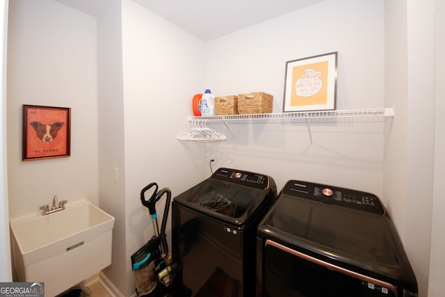 laundry room with laundry area, separate washer and dryer, and a sink