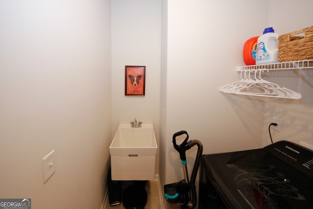 clothes washing area featuring laundry area and a sink