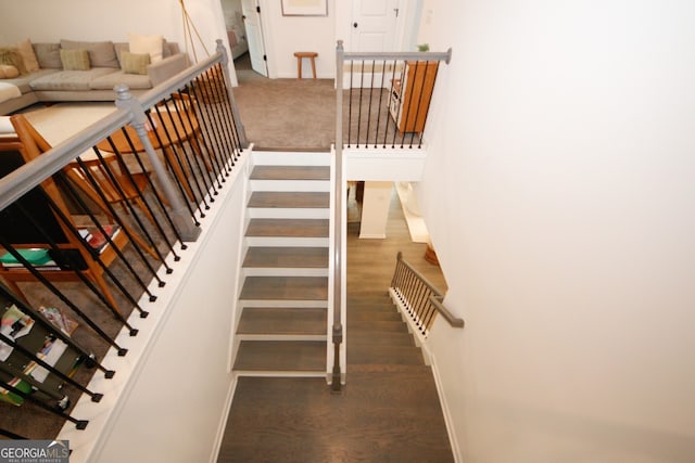 stairs with baseboards and wood finished floors