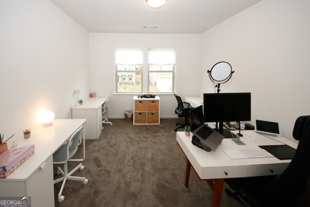 office area featuring baseboards and dark colored carpet