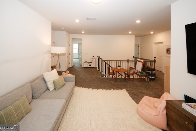 living area featuring visible vents, dark colored carpet, and recessed lighting