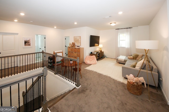 living room featuring visible vents, dark carpet, baseboards, and recessed lighting