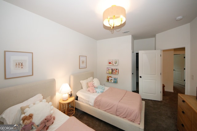 bedroom featuring visible vents and dark carpet