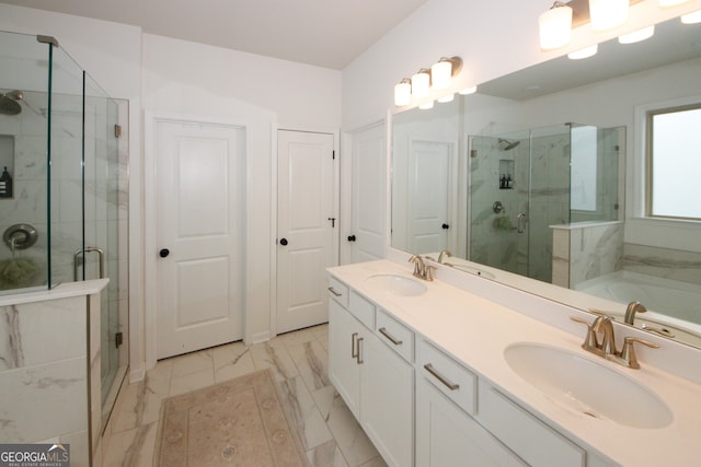 bathroom featuring a stall shower, marble finish floor, and a sink