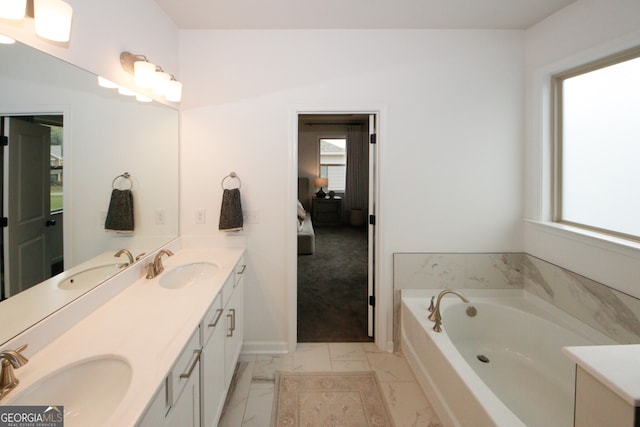 ensuite bathroom featuring double vanity, marble finish floor, ensuite bath, and a sink