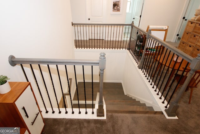 staircase with carpet flooring and baseboards