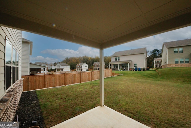 view of yard with a residential view, a patio, and fence