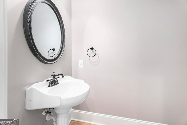 bathroom with wood-type flooring