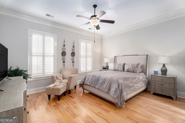 bedroom featuring crown molding, ceiling fan, and light wood-type flooring