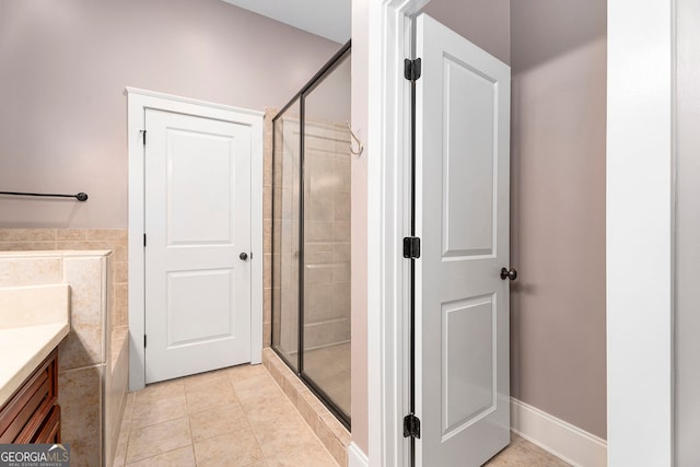 bathroom with tile patterned flooring, vanity, and a shower with shower door