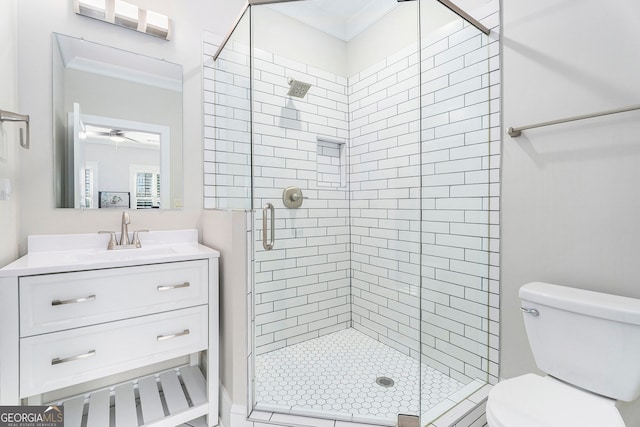 bathroom featuring a shower with door, ornamental molding, vanity, and toilet