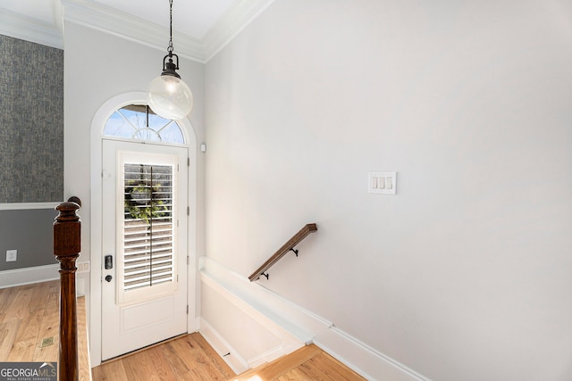 entrance foyer with crown molding and light hardwood / wood-style floors