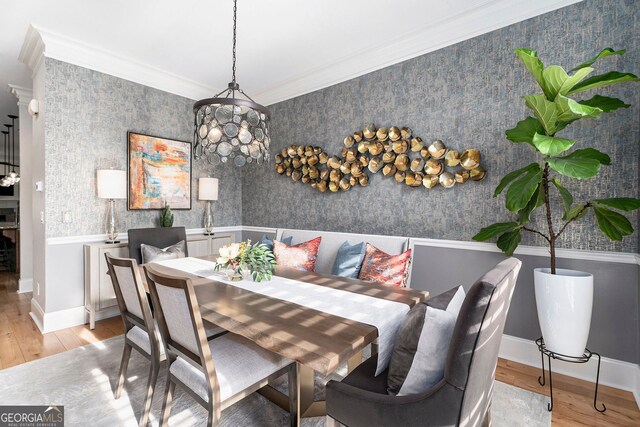 dining area featuring light hardwood / wood-style flooring and ornamental molding