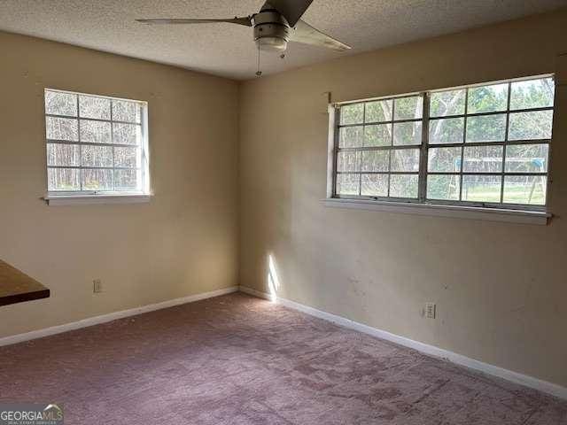 unfurnished room featuring ceiling fan, carpet, and a textured ceiling