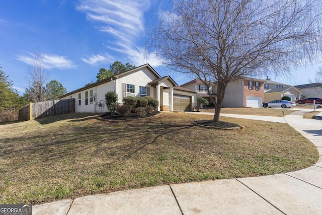 single story home with a garage and a front lawn