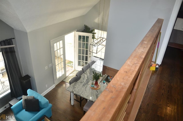 living room with plenty of natural light, dark hardwood / wood-style floors, and vaulted ceiling