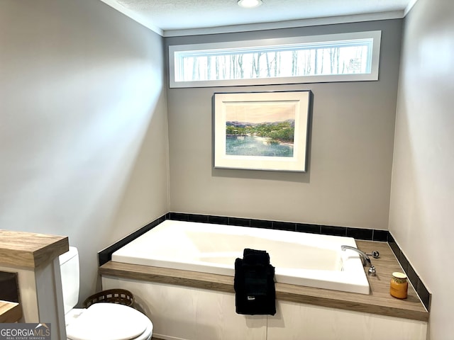 bathroom with toilet, a bath, and a textured ceiling