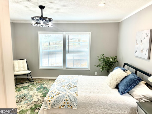 bedroom with ornamental molding and a textured ceiling