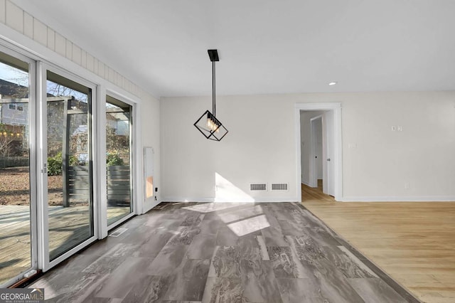 unfurnished dining area featuring hardwood / wood-style flooring