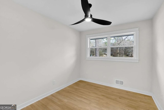 empty room featuring ceiling fan and light hardwood / wood-style flooring