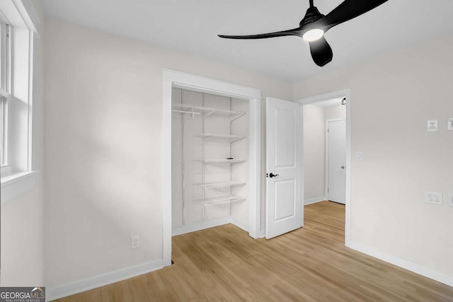 unfurnished bedroom featuring ceiling fan, a closet, and light hardwood / wood-style flooring