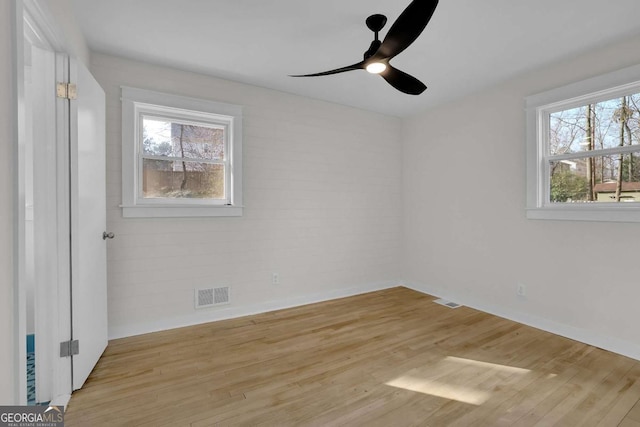 spare room featuring ceiling fan and light hardwood / wood-style floors