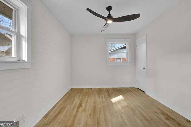 spare room with ceiling fan and light wood-type flooring