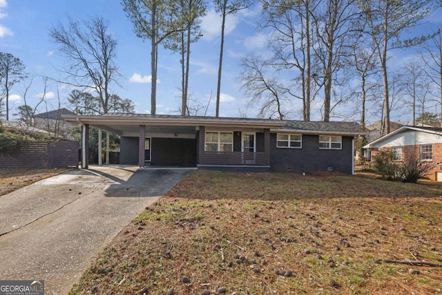 ranch-style house with a carport and a front lawn