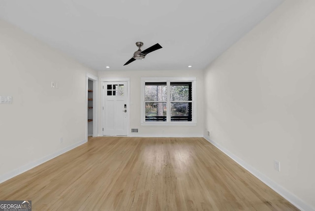 empty room with ceiling fan and light wood-type flooring