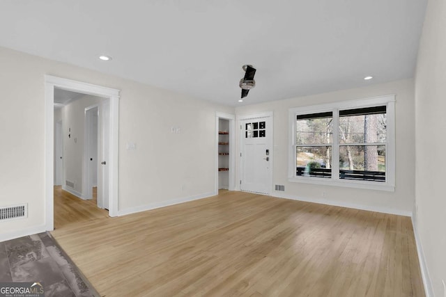 unfurnished living room with light hardwood / wood-style flooring