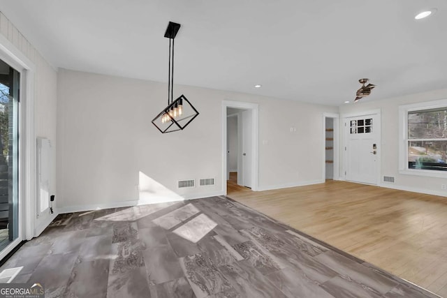 unfurnished dining area featuring wood-type flooring