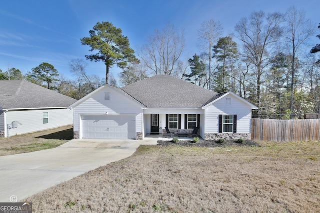 single story home with a porch, a garage, and a front lawn