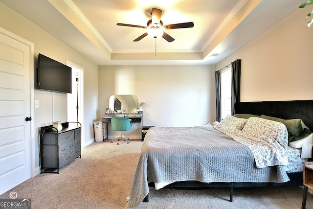 carpeted bedroom featuring crown molding, ceiling fan, and a raised ceiling