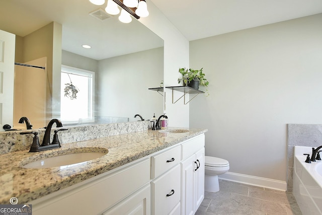 bathroom featuring a bathing tub, vanity, and toilet