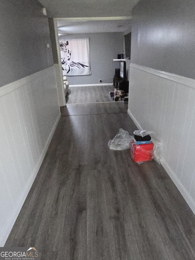 hallway with dark hardwood / wood-style flooring