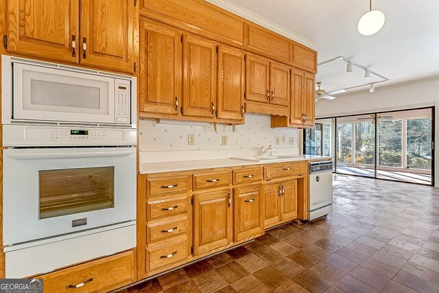 kitchen with pendant lighting, sink, white appliances, and ceiling fan