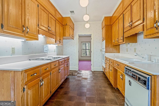 kitchen with white appliances, ornamental molding, sink, and hanging light fixtures