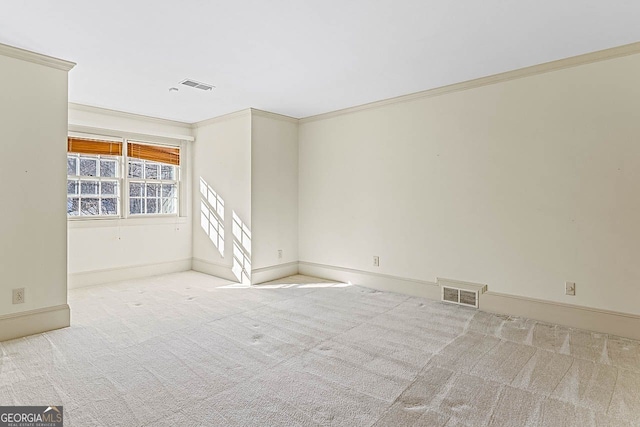 empty room with ornamental molding and light carpet