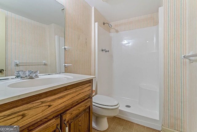 bathroom with vanity, toilet, and walk in shower