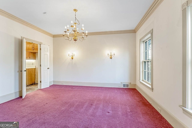 carpeted empty room with an inviting chandelier and ornamental molding